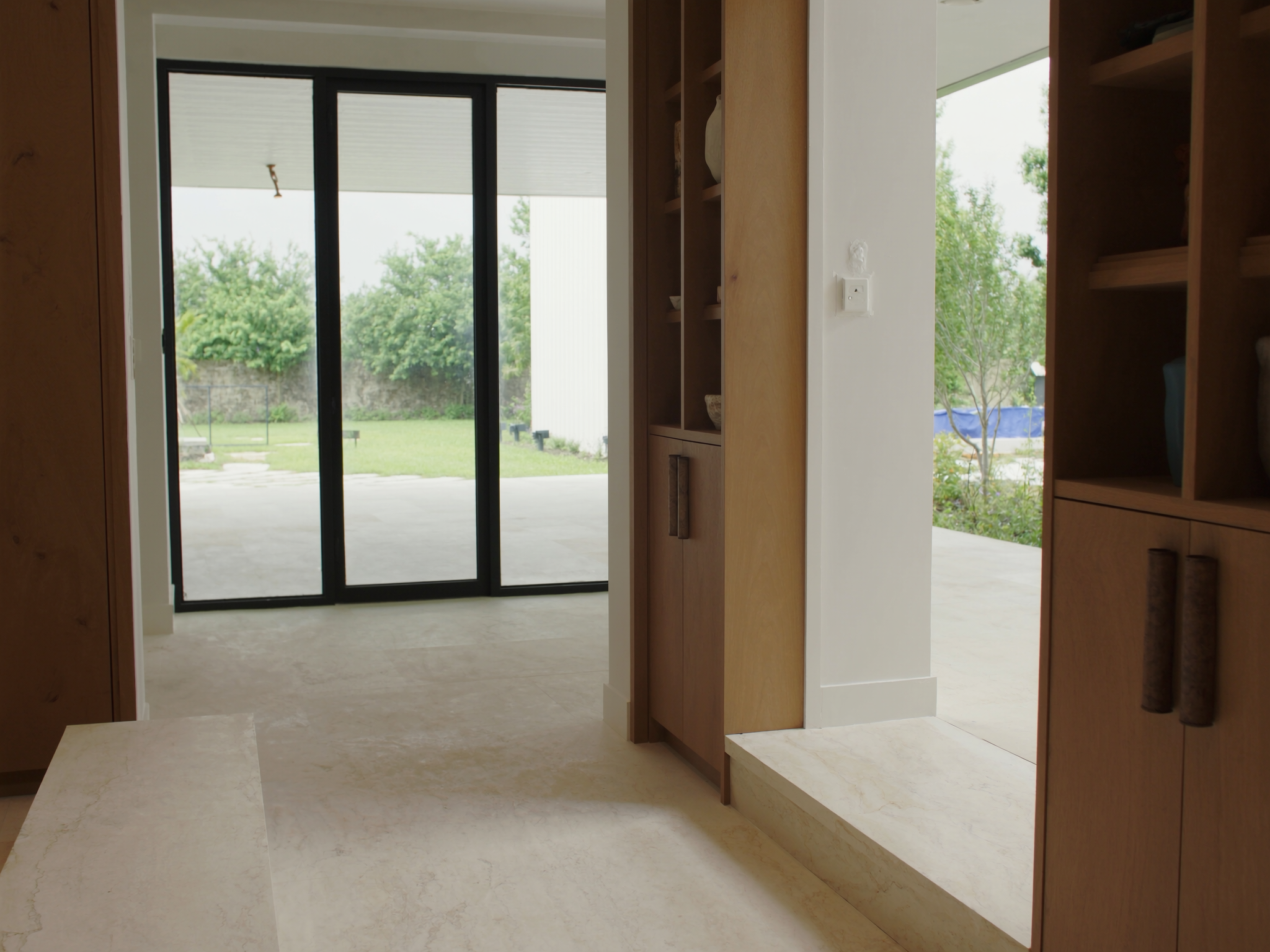 Completed upscale Florida home addition with warm millwork and outdoor access